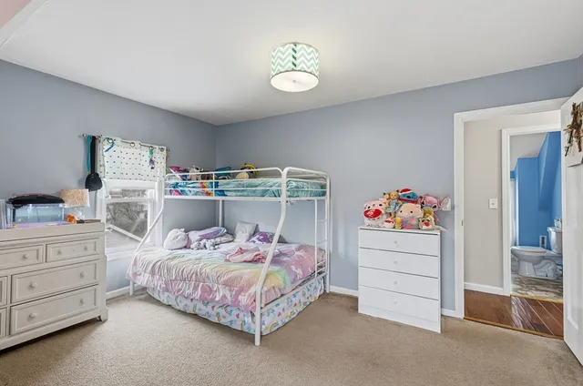 a bathroom with a toilet and shower curtain