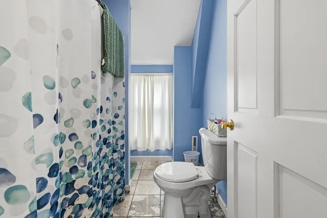 a view of a street with cars parked on the road