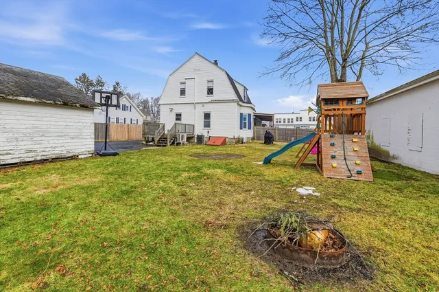 a view of a house with yard and sitting area