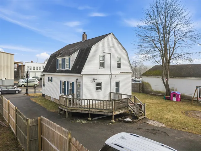 a view of a house with a yard and deck