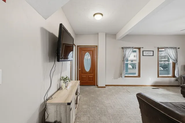 a living room with furniture and a chandelier