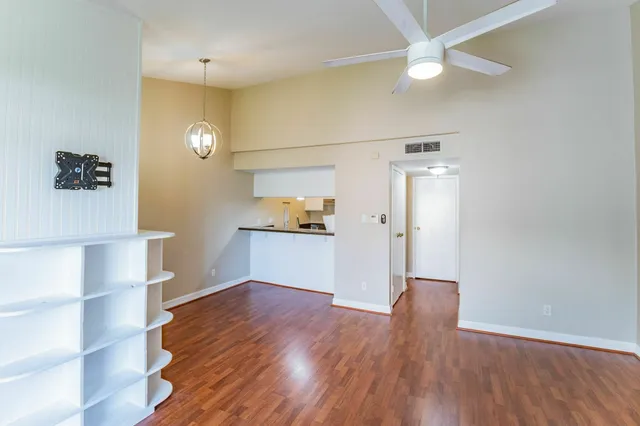 a view of empty room with wooden floor