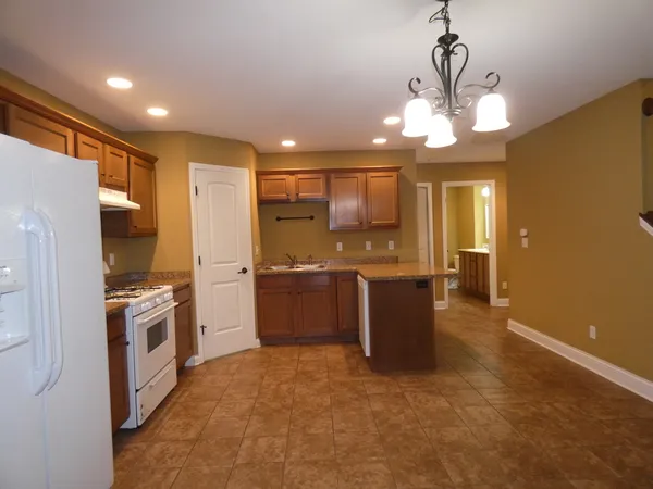 a large kitchen with a large window and stainless steel appliances