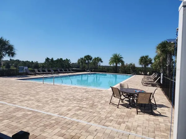 a view of a lake with table and chairs