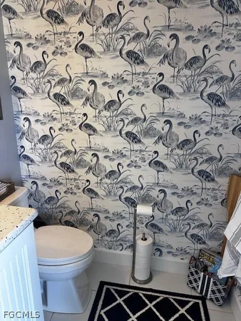 a white toilet sitting next to a shower curtain