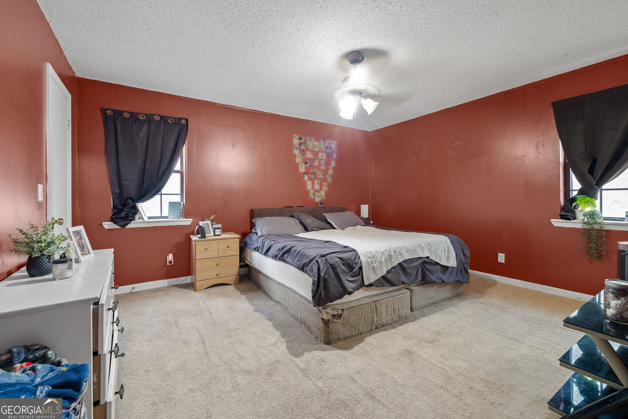89 Ts Jarrard Road Dahlonega, GA 30533 - Photo 13 of 48 a bedroom with a bed potted plant on dresser and a chandelier