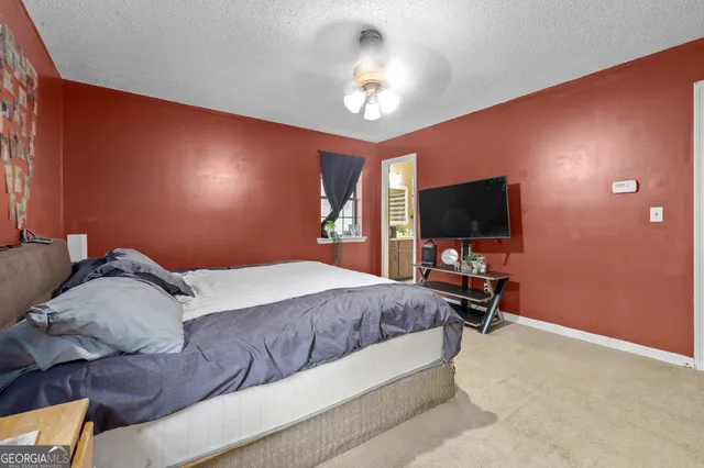 a bathroom with a sink a toilet a mirror and shower curtain