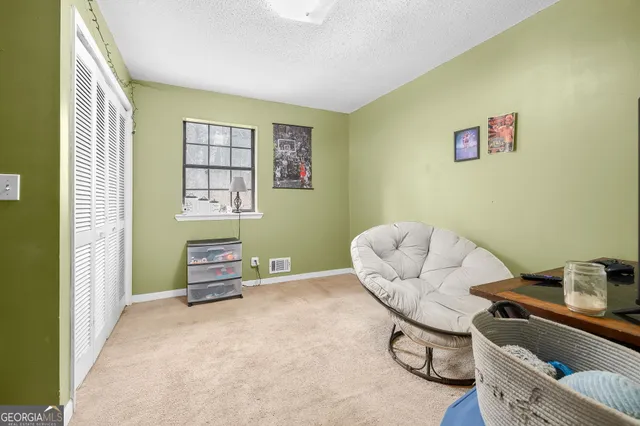 a view of a livingroom with furniture and cabinet