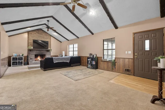 a living room with furniture a fireplace and windows