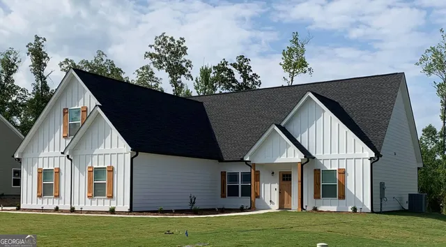 a front view of a house with a garden