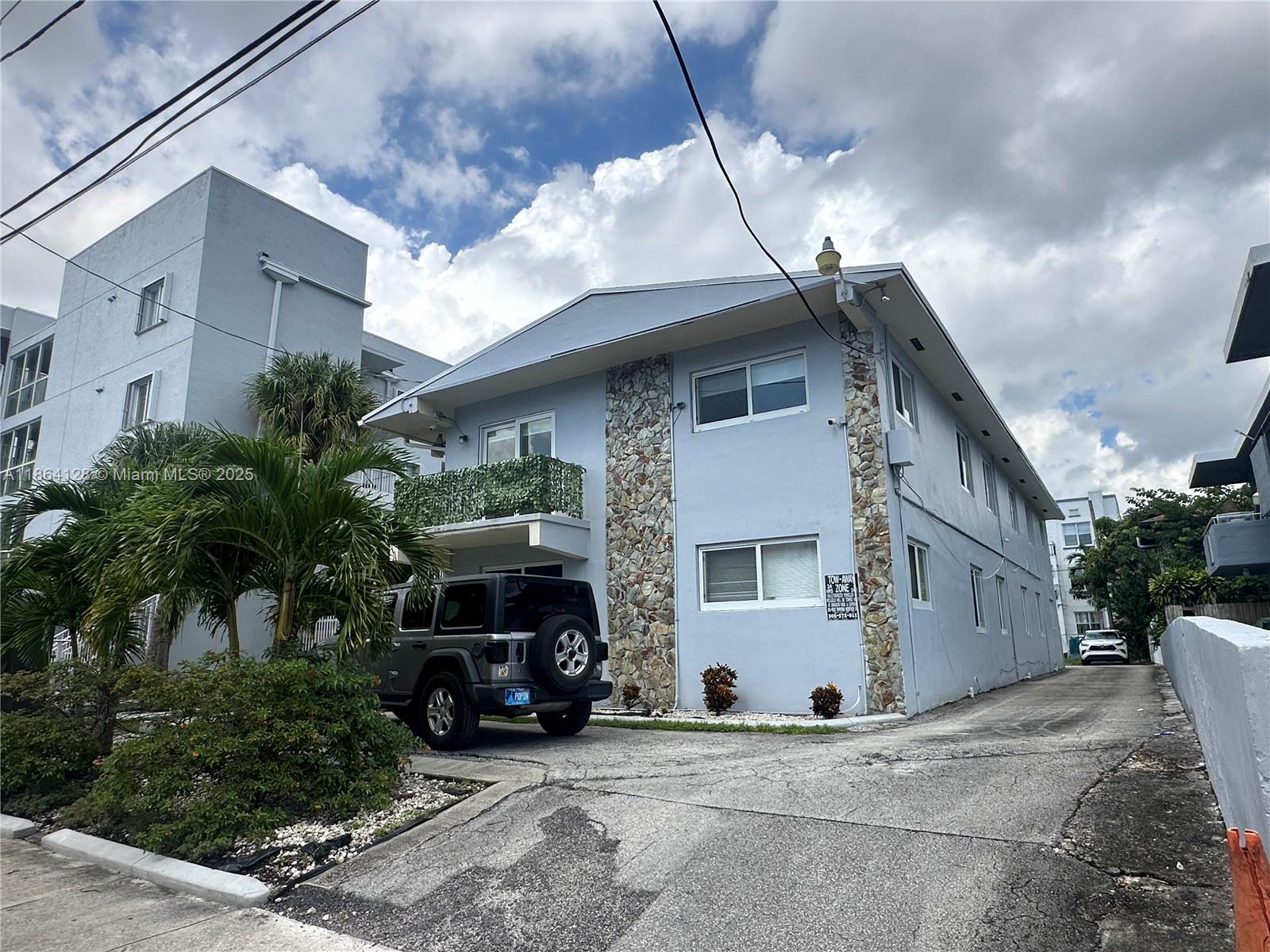 627 Southwest 3rd Street, Unit 4 Miami, FL 33130 - Photo 12 of 12 a view of a house with a patio and a yard