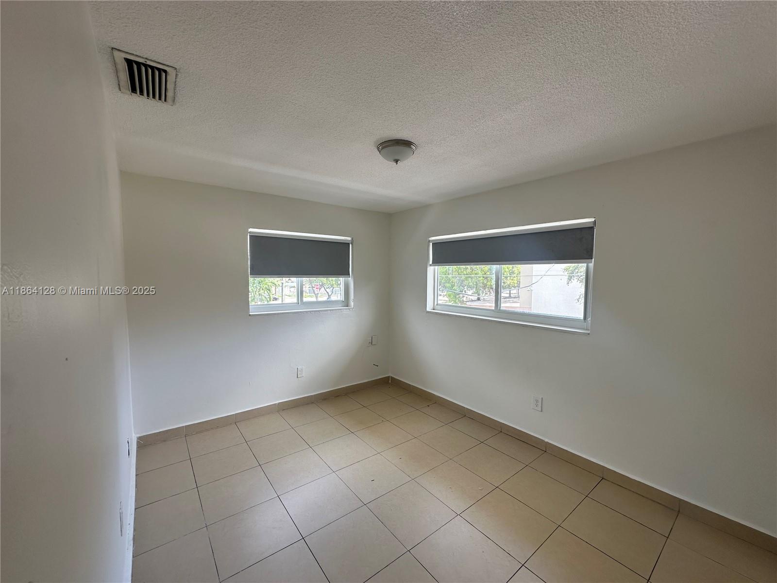 627 Southwest 3rd Street, Unit 4 Miami, FL 33130 - Photo 4 of 12 an empty room with windows