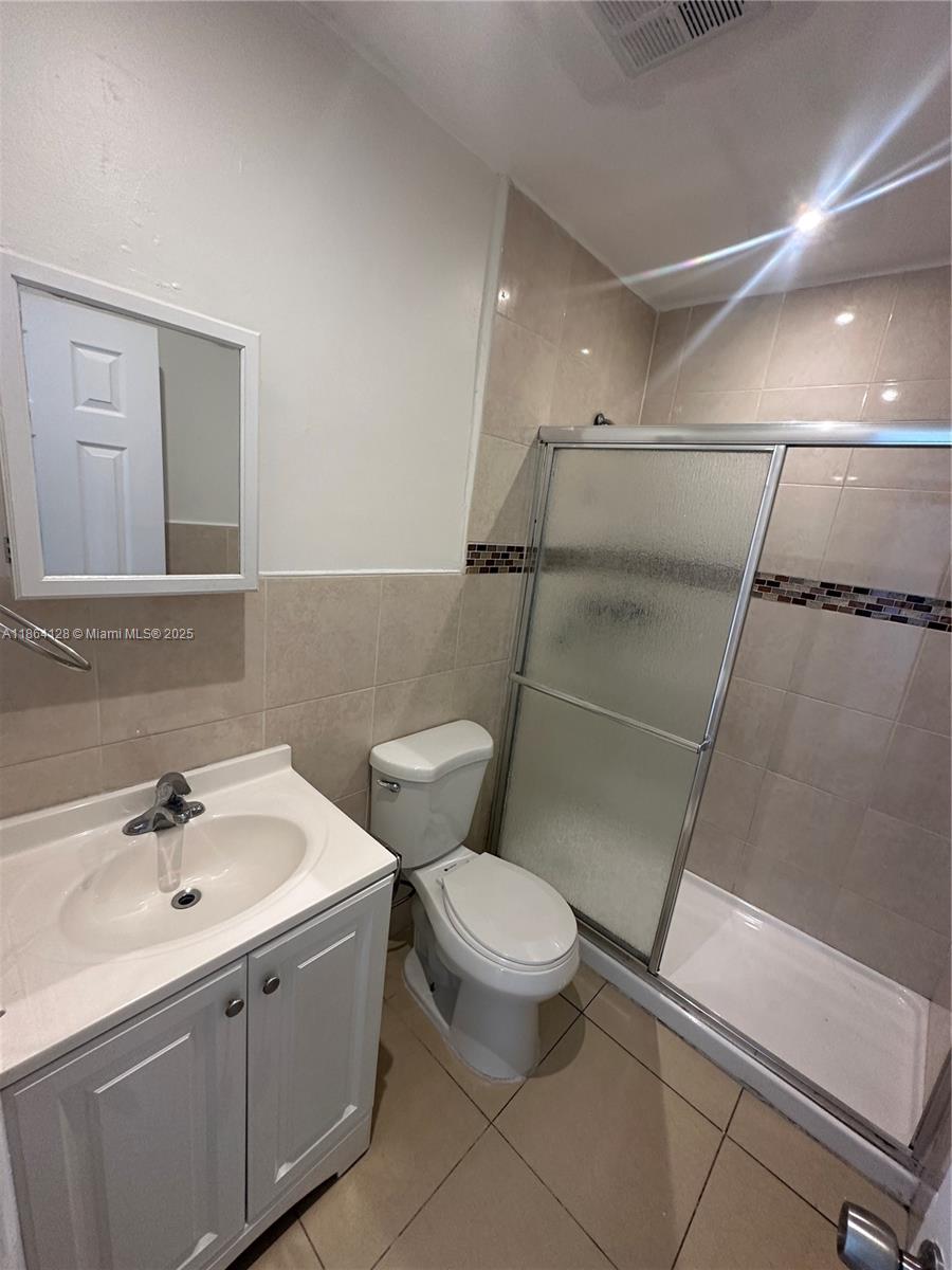 627 Southwest 3rd Street, Unit 4 Miami, FL 33130 - Photo 6 of 12 a bathroom with a toilet sink and mirror