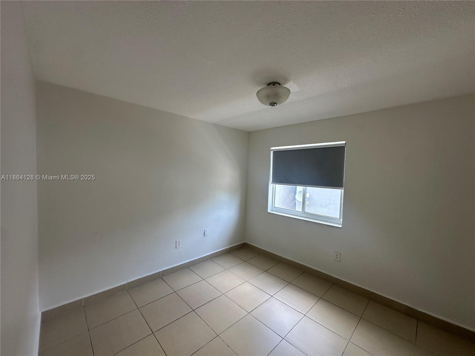 627 Southwest 3rd Street, Unit 4 Miami, FL 33130 - Photo 7 of 12 a view of an empty room with a window