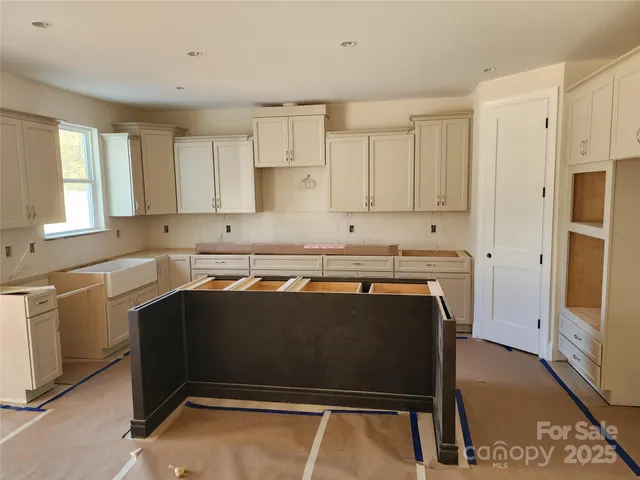a kitchen with kitchen island a sink dishwasher a stove and a refrigerator