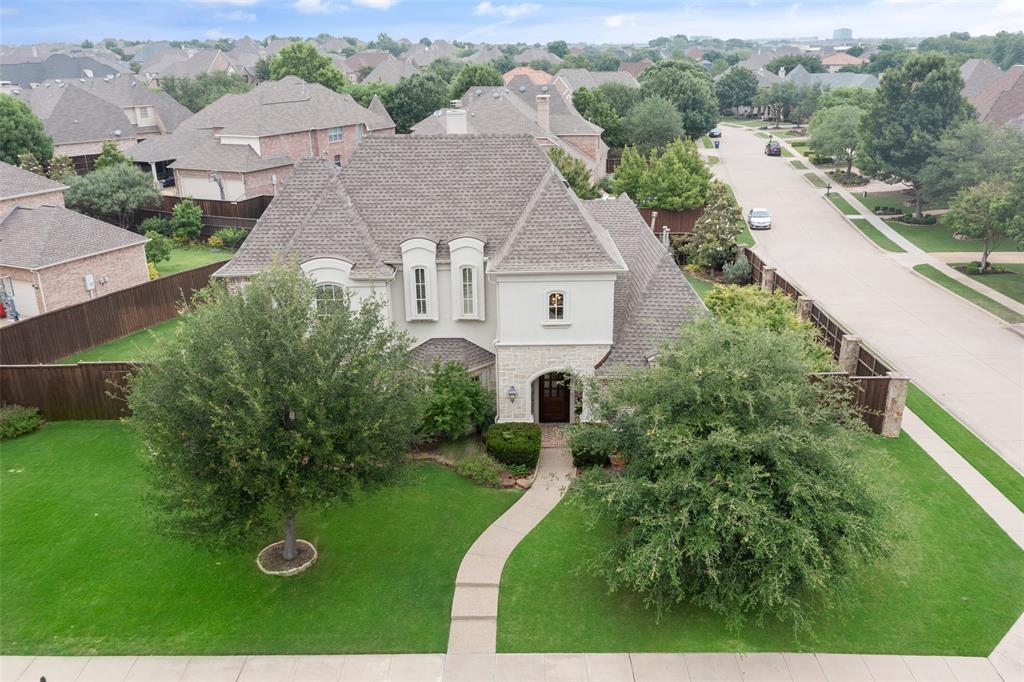an aerial view of a house with yard