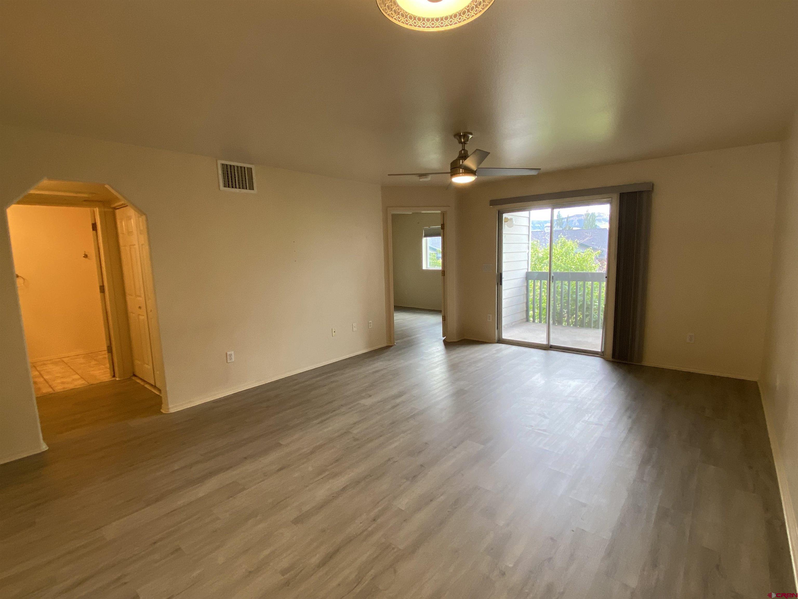 1100 Goeglein Gulch Road, Unit 131 Durango, CO 81301 - Photo 5 of 18 a view of an empty room with a window and wooden floor