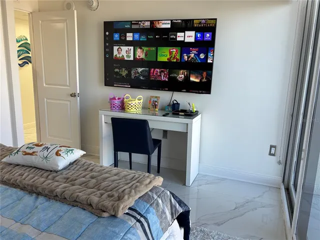 a bedroom with a bed and a flat screen tv