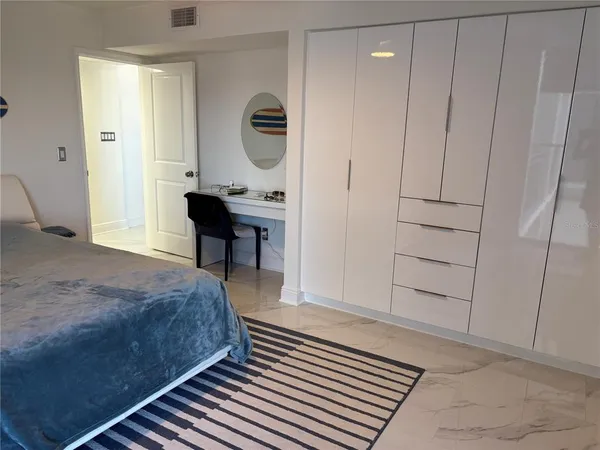a bed sitting in a bedroom next to a window