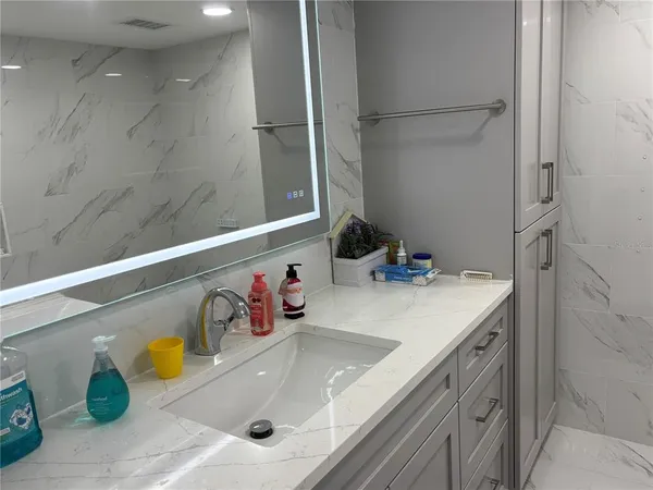 a bedroom with a bed and large window