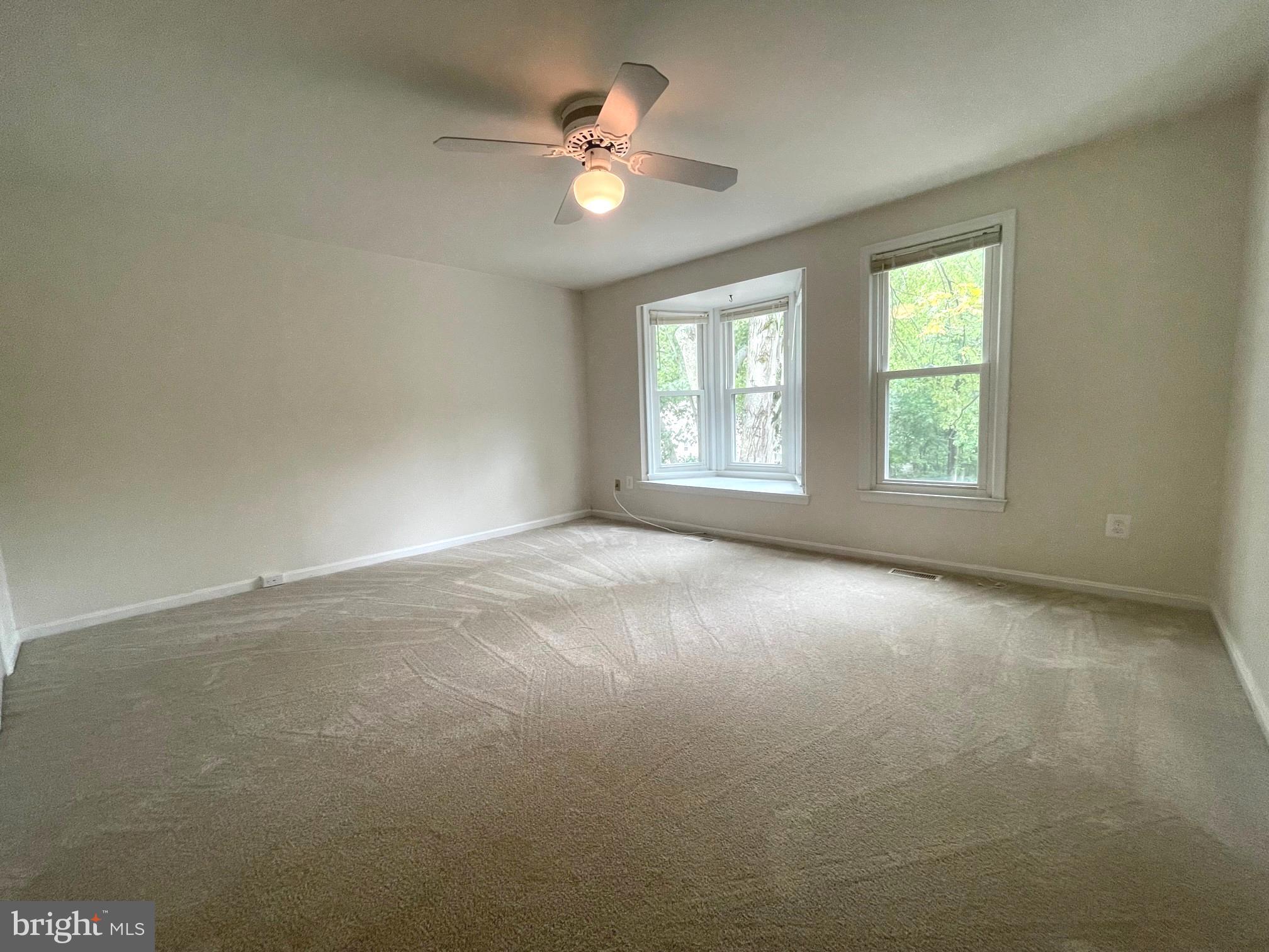 2119 Whisper Way Reston, VA 20191 - Photo 15 of 17 an empty room with windows and ceiling fan