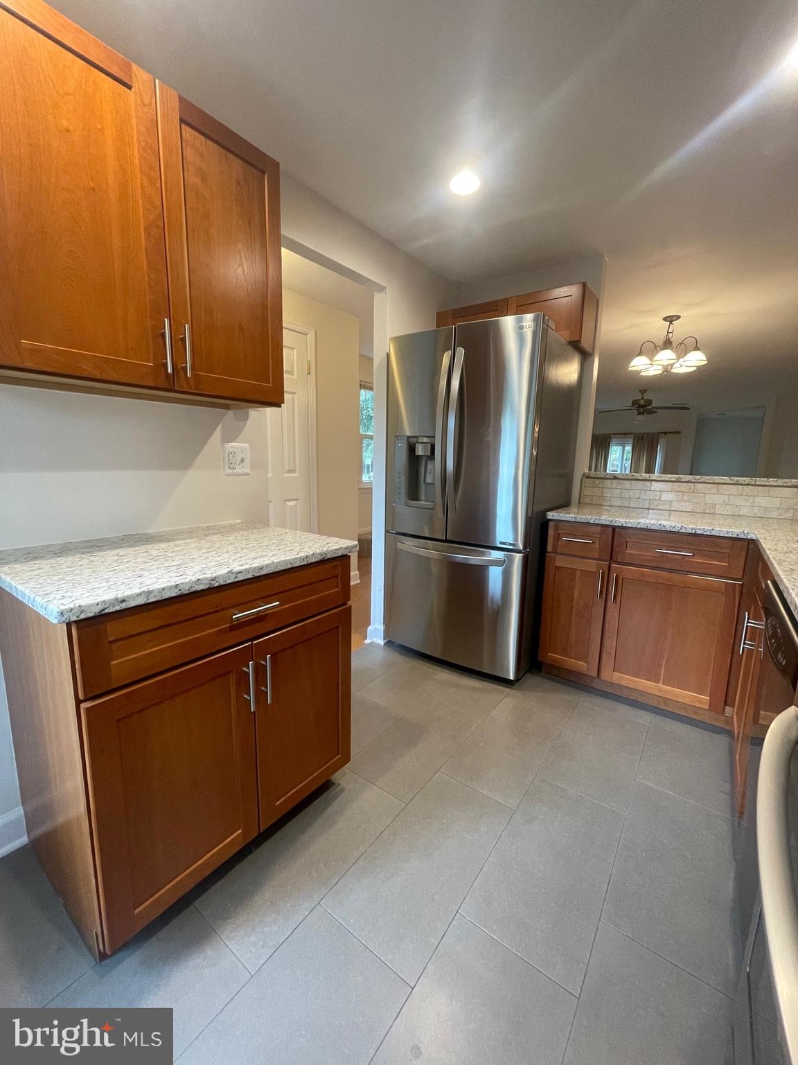 2119 Whisper Way Reston, VA 20191 - Photo 4 of 17 a kitchen with stainless steel appliances granite countertop a refrigerator and a sink