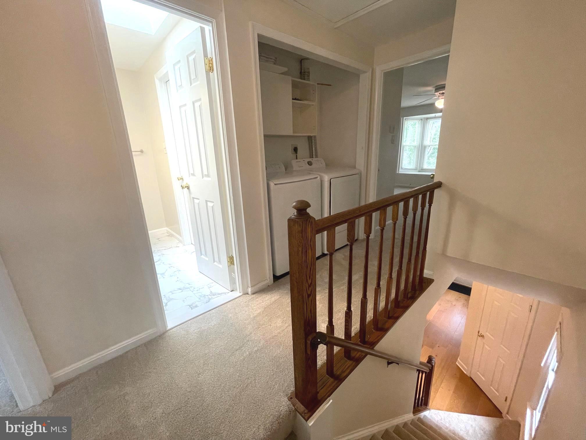 2119 Whisper Way Reston, VA 20191 - Photo 9 of 17 a view of a hallway with wooden floor and stairs