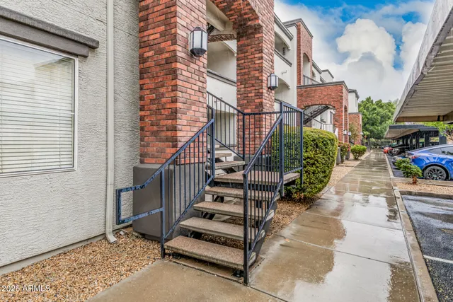 a view of a hallway with wooden floor and a living room
