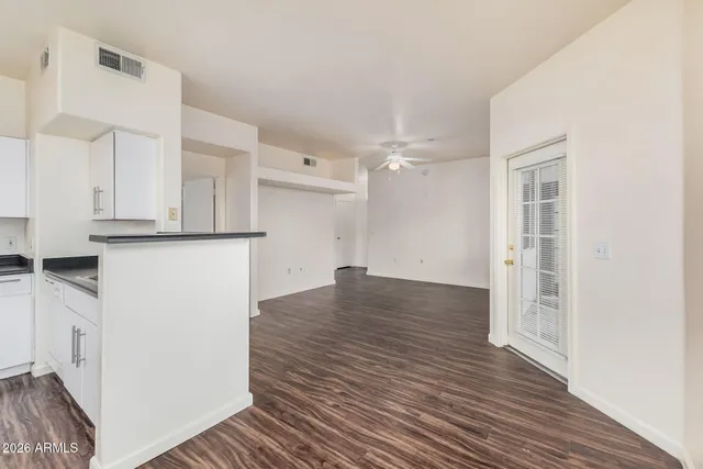 a kitchen with white cabinets and appliances