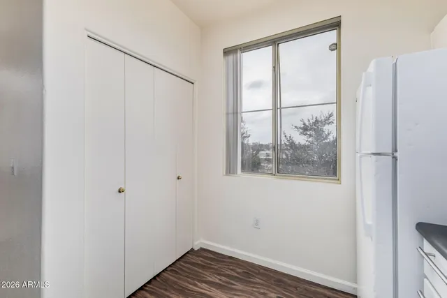 a view of a big room with chandelier fan and windows