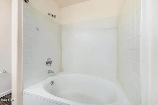 a view of an empty room and a ceiling fan