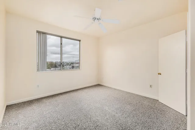a bathroom with a granite countertop sink a mirror and a shower