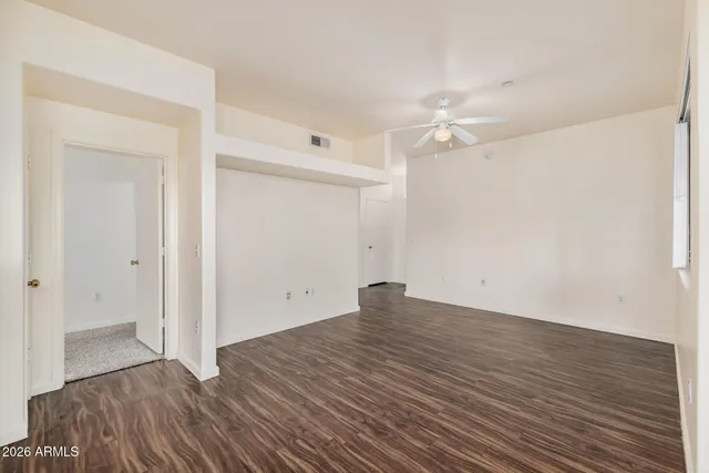 a view of a kitchen with wooden floor and a sink