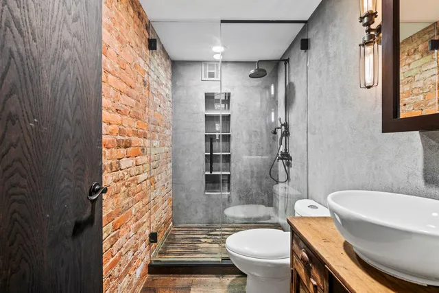 a bathroom with a sink toilet and shower