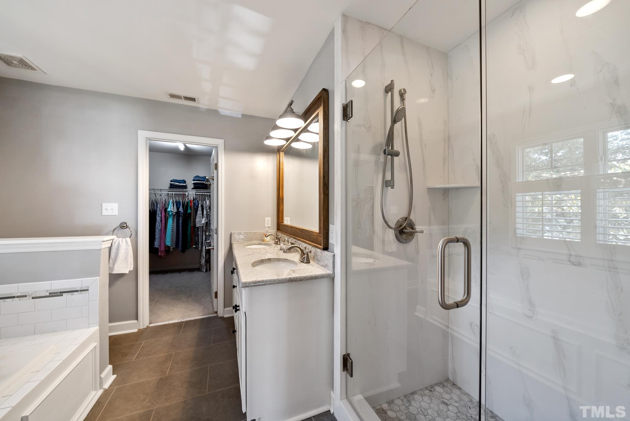 7909 Broad Street Raleigh, NC 27613 - Photo 22 of 27 a en suite bathroom with a shower sink and mirror