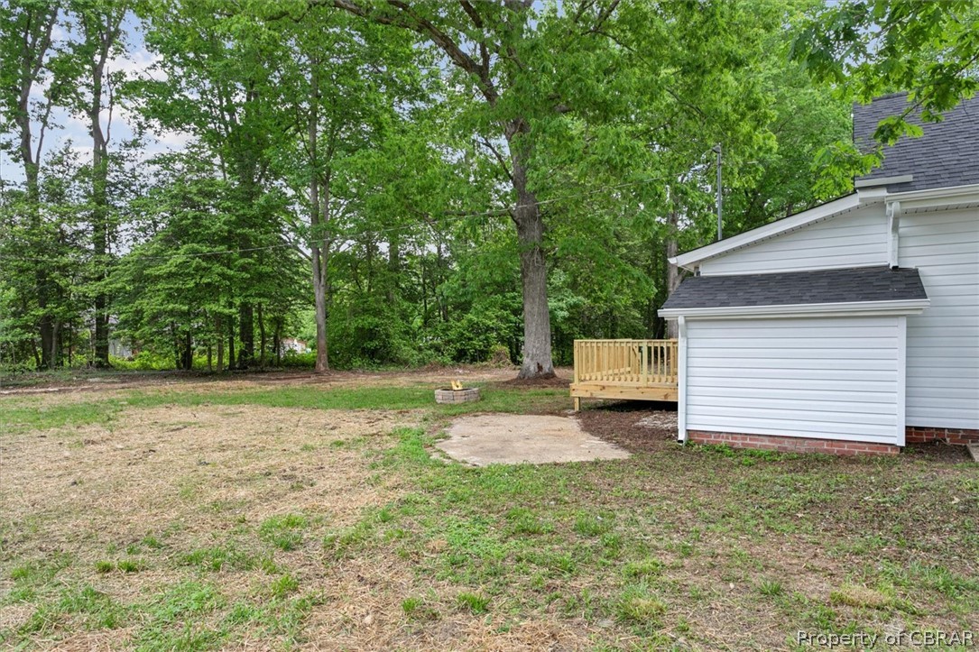 8213 Croaker Road Williamsburg, VA 23188 - Photo 33 of 50 View of yard with a wooden deck