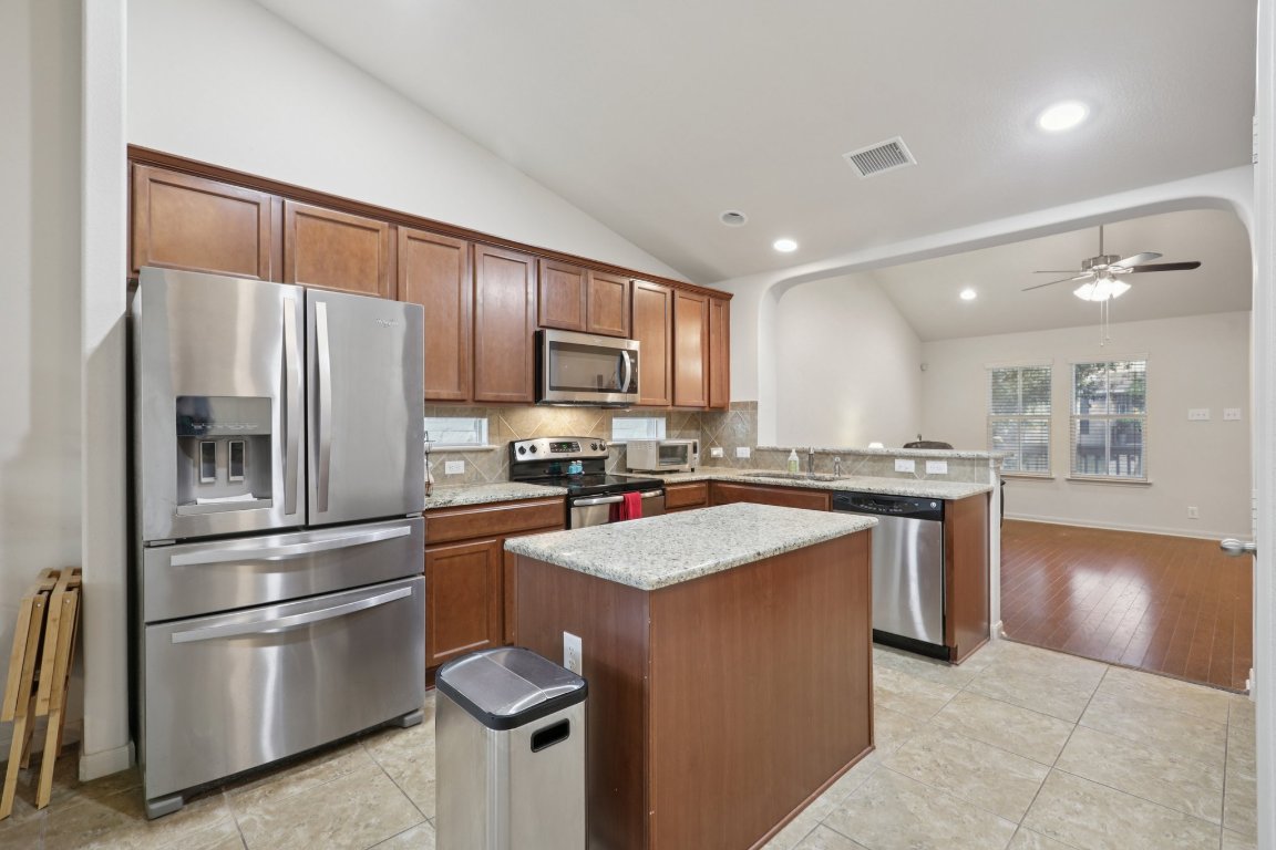1621 Big Thicket Drive Cedar Park, TX 78613 - Photo 12 of 37 a kitchen with stainless steel appliances granite countertop a refrigerator stove microwave and sink