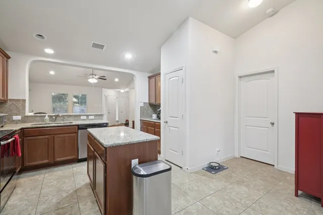 a bathroom with a granite countertop sink mirror bathtub and shower