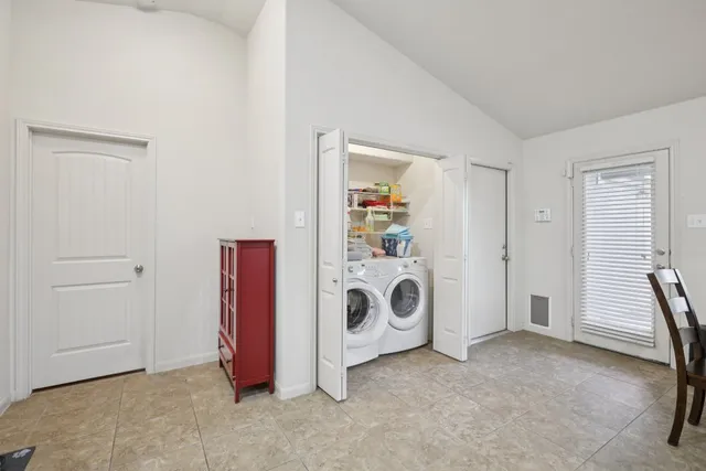 a view of a storage & utility room with closet window
