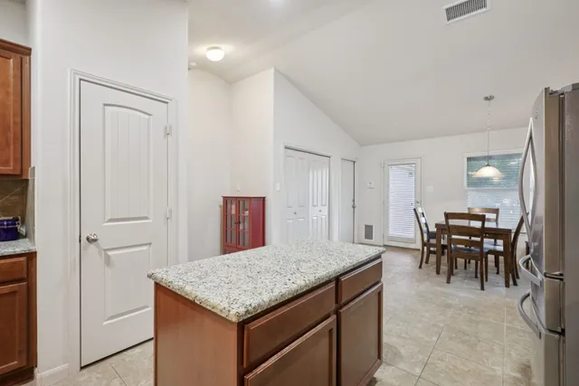 a kitchen with a table and chairs