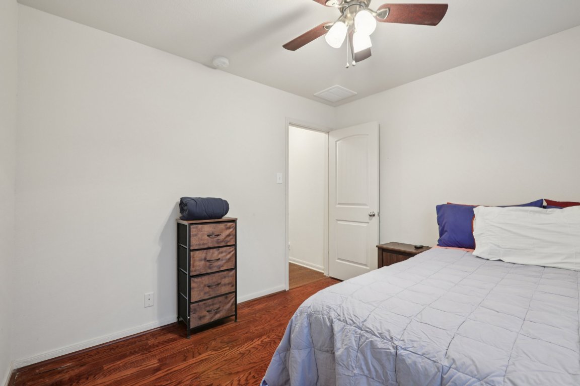 1621 Big Thicket Drive Cedar Park, TX 78613 - Photo 22 of 37 a bedroom with a bed and wooden floor