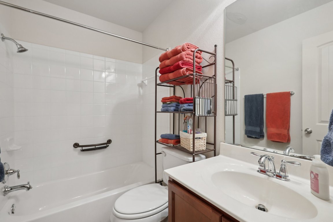 1621 Big Thicket Drive Cedar Park, TX 78613 - Photo 23 of 37 a bathroom with a sink vanity mirror and toilet