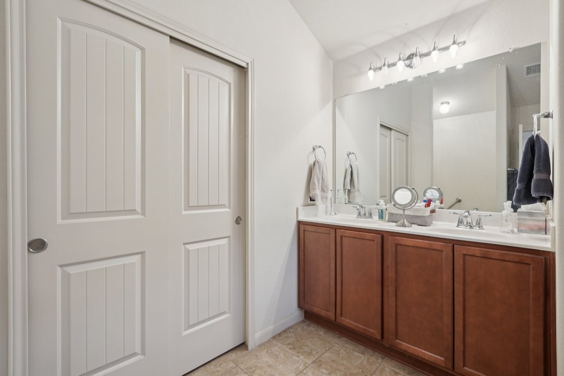 1621 Big Thicket Drive Cedar Park, TX 78613 - Photo 25 of 37 a bathroom with a double vanity sink and a mirror