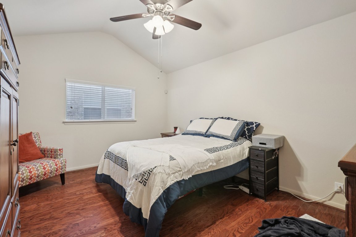 1621 Big Thicket Drive Cedar Park, TX 78613 - Photo 26 of 37 a bedroom with a bed and a chandelier