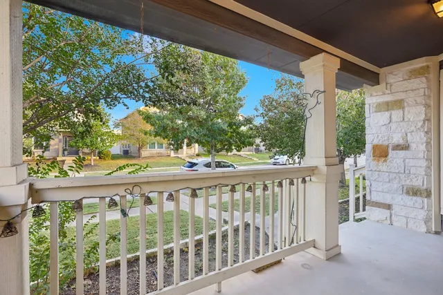 a view of a balcony with wooden floor