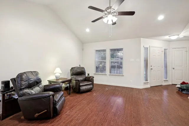 a living room with furniture and wooden floor