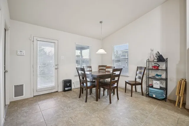 a view of a dining room with furniture and a window