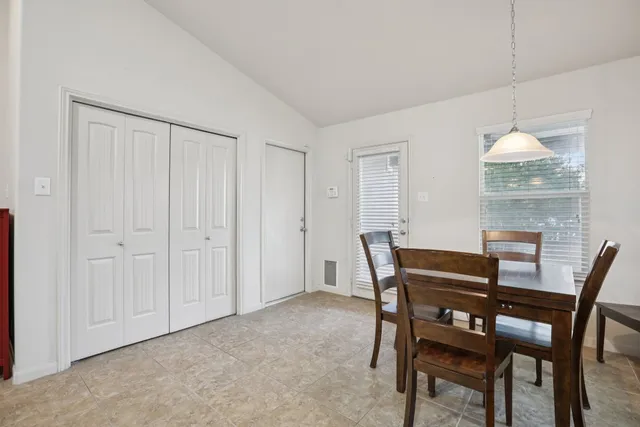a view of a dining room with furniture and chandelier