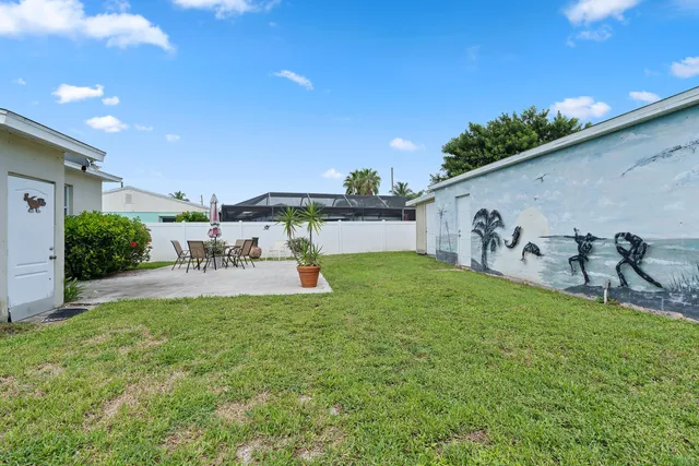 a view of a backyard with plants and a patio