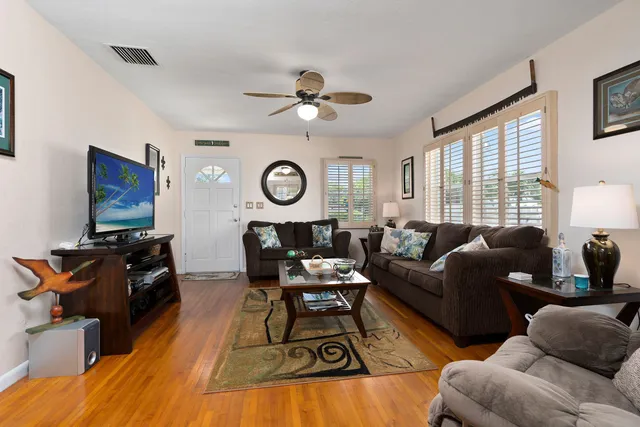 a living room with furniture a fireplace and a window